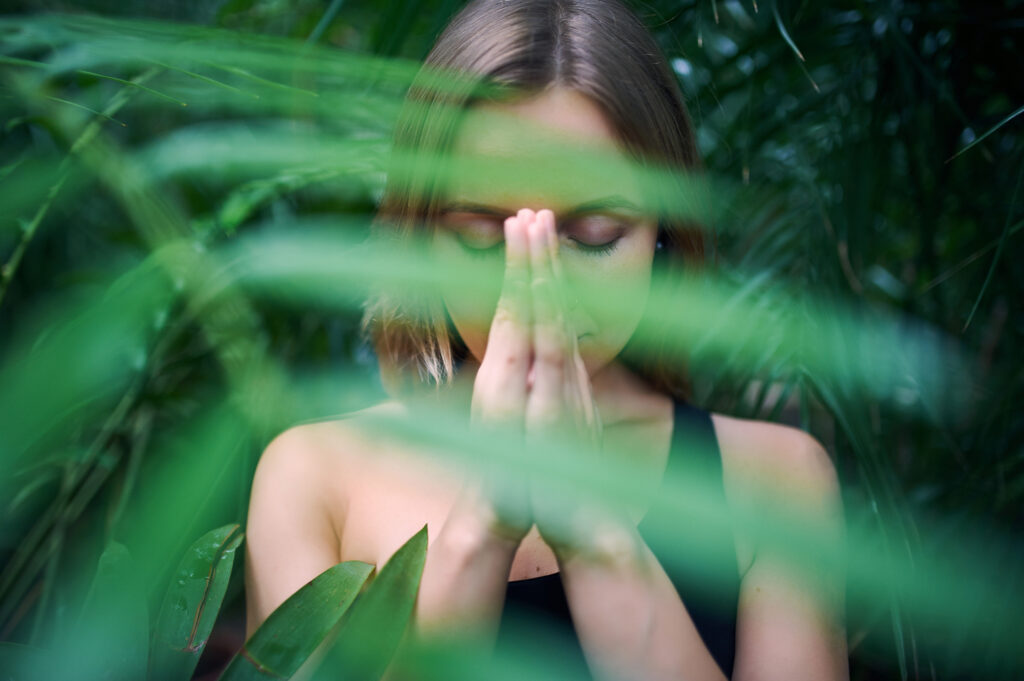 Female practising mindfulness for good health in nature.