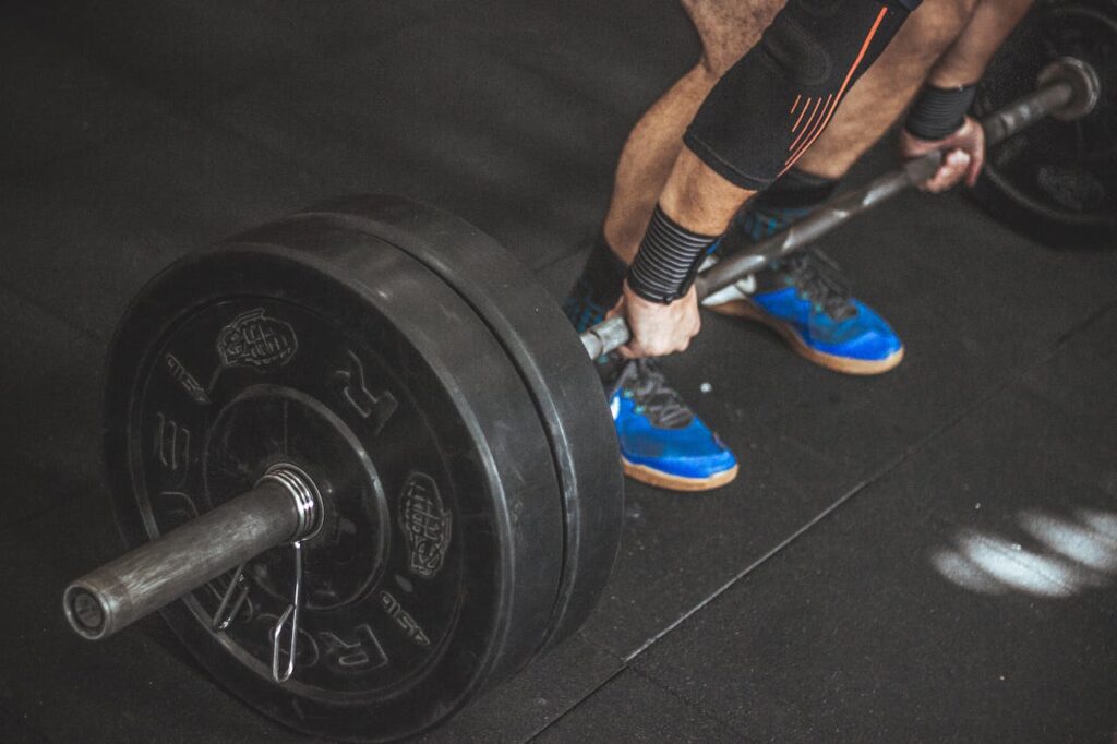 A man trying to lift a 25kg barbell.