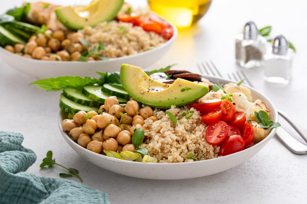 Protein based diet meal with quinoa, chickpeas, cucumber slices, and fresh herbs. 