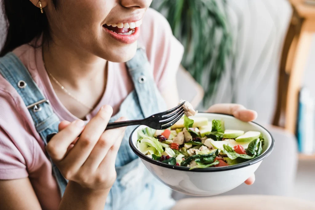 A woman maintaining a balanced diet to gain the benefits of healthy eating for supporting the immune system and overall well-being.