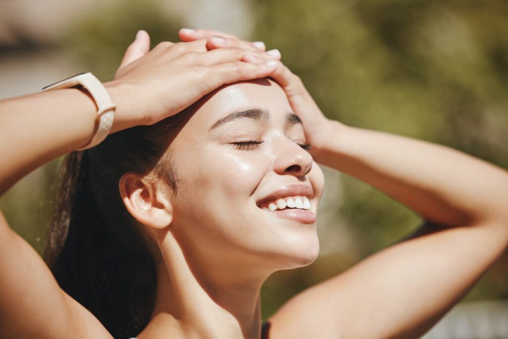 Young woman managing stress by staying positive and spending time outdoors in nature.