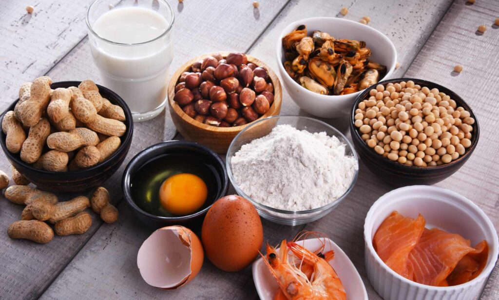 A photo showing common allergens, including peanuts, milk, eggs, shrimp, and soybeans, representing food allergies.